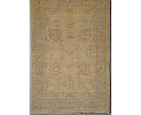 A Ziegler rug, with floral and foliate decoration in an ivory field and associating border set upon a light blue ground, 188x