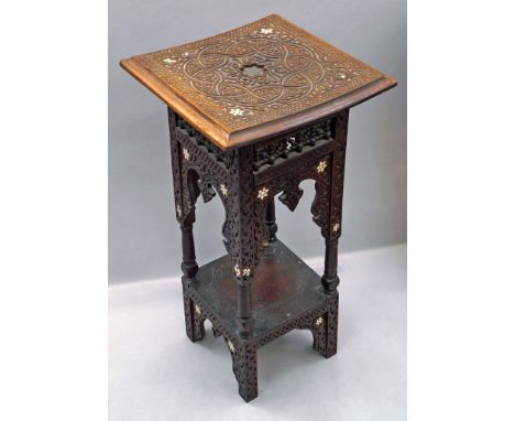 A Middle Eastern table, early 20th century, with square top carved with geometrical rope and stylised foliate designs, on a g