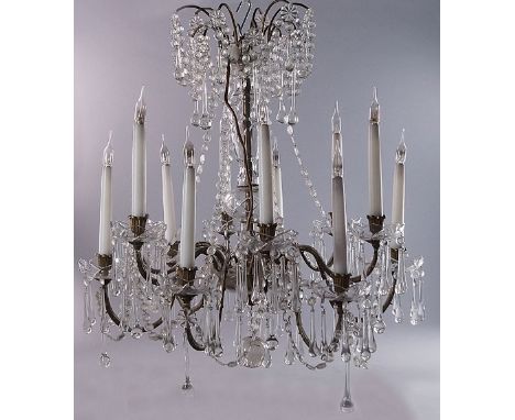 A twelve light lustre hung chandelier, 20th century, with glass bulbous column, with floral metal sconces and bowl form drip 