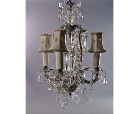 A four light glass framed chandelier, 20th century, with central faceted spike, the sconces and frame hung with droplets and 