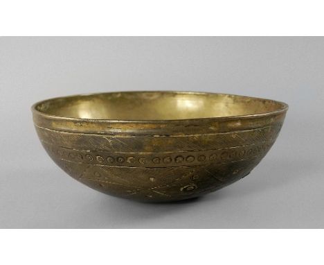 A bronze bowl, Afghanistan, c.12th/13th Century, of shallow form, with scratch and cross-hatch decoration, stylised panels an