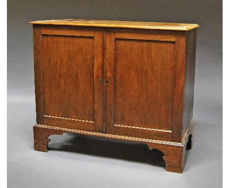 A George III rectangular linen press, panelled cupboard doors, raised on bracket feet, interior shelving, 102cm high x 119cm 