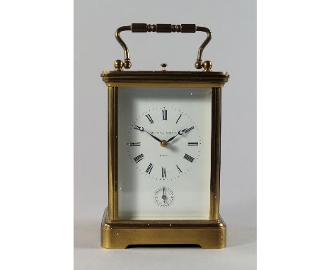 A brass carriage clock by Matthew Norman, 20th century, with plain rectangular case, the white enamel dial with Roman numeral