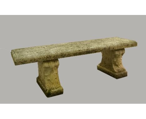 A composition stone garden bench with rectangular top, on scrollng supports, 142cm wide
