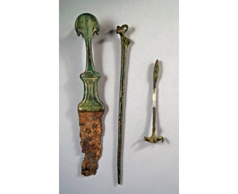 A Luristan bronze handled dagger, Circa 500-700 BC, the handle surmount with splayed inverted crescents, over fragment of iro