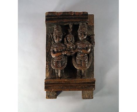 An Indian hardwood carved architectural panel, 19th/20th century, decorated with relief carving of parents and a child, possi
