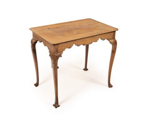 A George II mahogany silver table, Irish, the rectangular dished top above a shaped apron on shell carved legs with scroll fe