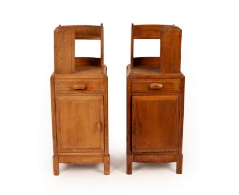 A pair of Arts & Crafts style walnut bedside tables, with raised superstructure above a single drawer and cupboard, by Brynma