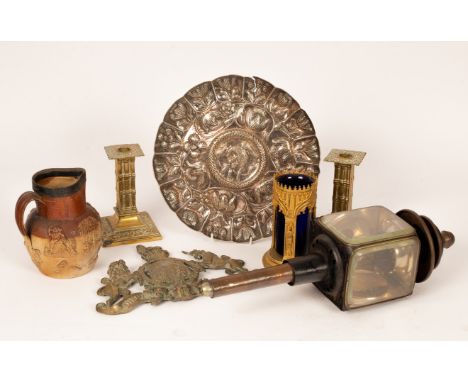 A white metal charger decorated a central bird surrounded by flowers, 31cm diameter, a brass plaque of the Royal Coat of Arms