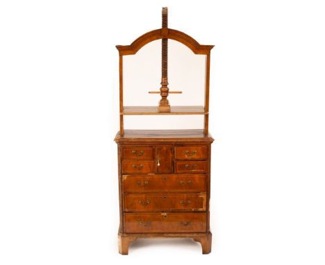 A Queen Anne walnut and oak press, circa 1710, the press upon and screw thread within an arch topped frame, upon a chest of f