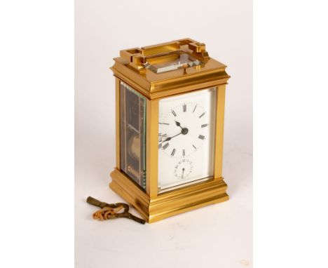 A gilt brass eight-day carriage alarm clock, half-hour repeat, hour strike, with white enamel dial and subsidiary alarm dial 