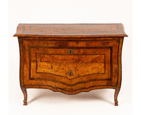 An 18th Century Italian burr oak and elm bombé fronted commode, the serpentine top banded with shaped lines, the front and si
