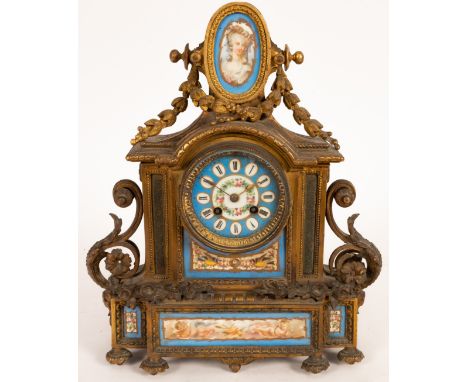 A gilt metal and porcelain mantel clock, twin-train movement striking a bell, decorated an oval portrait of a society lady to