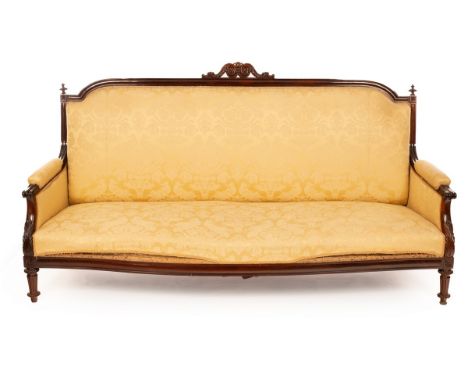 A William IV rosewood sofa, the arched back with scroll motif to the crest rail, the upholstered back, arms and seat on turne