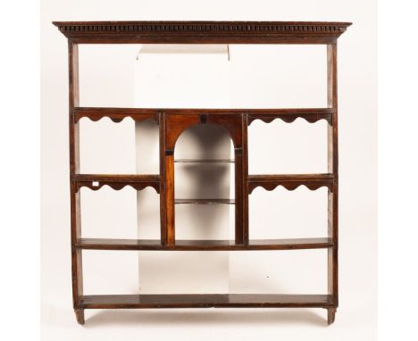 A set of oak and mahogany hanging shelves with central arch recess, 112cm wide CONDITION REPORT: Scratches, stains and other 