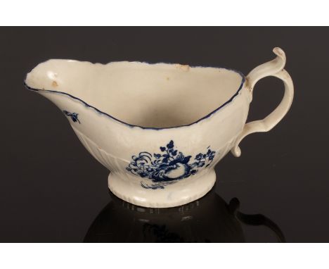 A Caughley sauce boat, circa 1780, the moulded rim above pleat moulded lower part, printed with fruit, 21cm long CONDITION RE