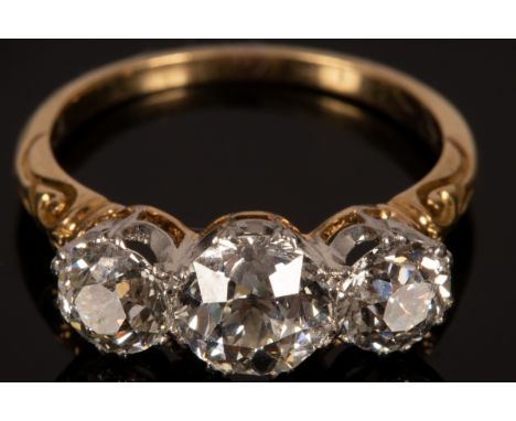 A diamond three-stone ring, the central stone of approximately 1.5ct, the flanking diamonds of approximately 0.7ct each, claw