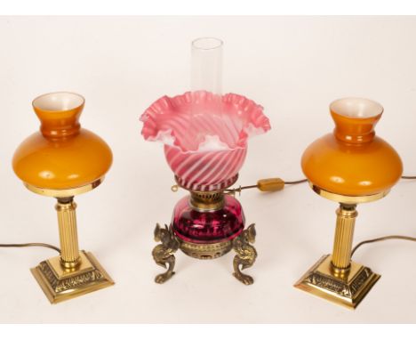 A Victorian opaque pink glass oil lamp with brass griffin support, 43cm high and two others CONDITION REPORT: Condition infor
