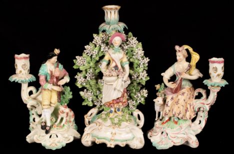 A matched pair of Derby figural single branch candlesticks, with Shepherd and Shepherdess and a Derby style figural candlesti