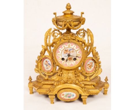 A gilt metal mounted mantel clock, with urn finial and porcelain panels to the sides and base, 33cm high CONDITION REPORT: Co