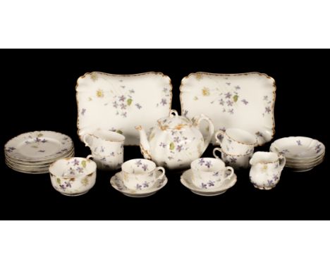 A Haviland Limoges tea service moulded with fluted panels and decoration with lightly trailing flowers, comprising a teapot, 