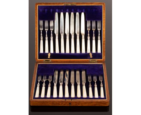 A cased set of twelve silver dessert knives and forks, with pearl handles, TL, Sheffield 1913, the oak case with inscription 