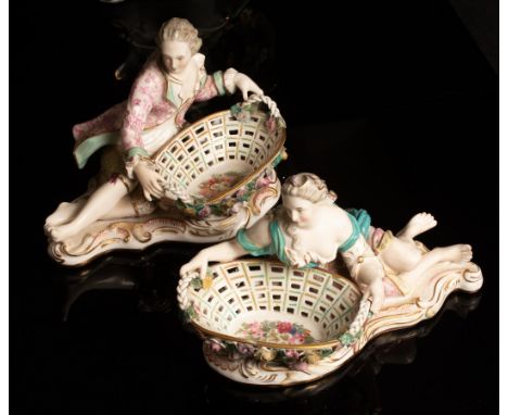 A pair of Sitzendorf porcelain sweetmeat baskets with recumbent gallant and companion, 24cm long together with a Derby style 