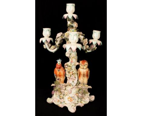 A German porcelain flower encrusted four-light candelabrum, modelled with an owl and parrot, 43cm high CONDITION REPORT: Prof