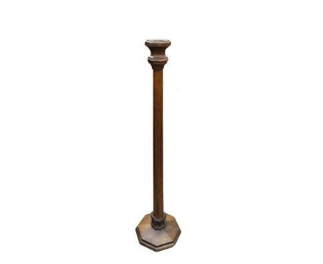 A Gothic oak altar stick, the octagonal column to base with carved frieze on a spreading foot 139cm (54in)  