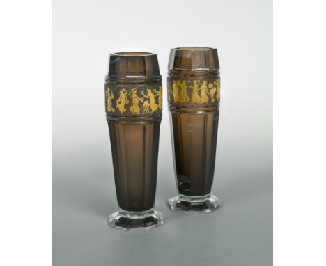 A pair of Moser glass vases, the facetted amethyst glass vases each etched and gilded with a frieze of dancing Classical figu