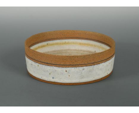 § Robin Welch, (British, born 1936), a stoneware bowl, of straight sided circular form, impressed mark 7 x 22cm (3 x 9in)  