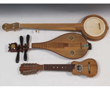 A Chinese lute or Liuqin; armadillo skin Bolivian miniature instrument with 10 strings and a 5 string mountain banjo (3)