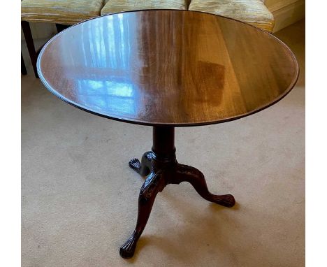 A George III mahogany tilt top supper table with carved tripod legs