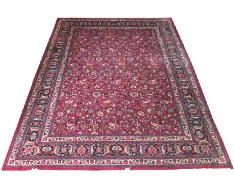 PERSIAN MASHAD CARPET, 332cm x 250cm, all over palmetter and scrolling vine design on a ruby field inside multiple correspond