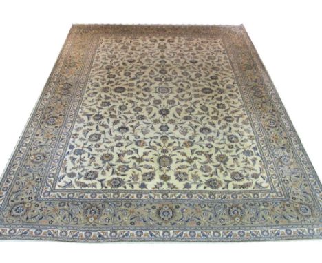 FINE KASHAN CARPET, 400cm x 305cm, all over scrolling palmettes and vines on an ivory field within a corresponding old gold b