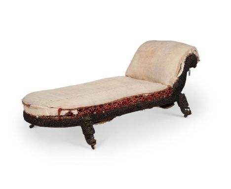 Y A HARDWOOD ANGLO-INDIAN PADOUK DAYBED  19TH CENTURY  with elaborate carving  84cm high, 218cm wide, 74cm deep  Condition Re