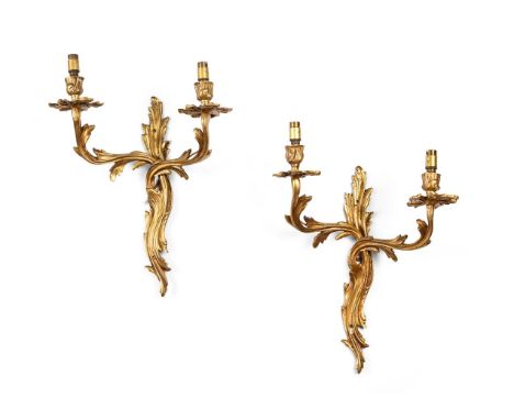 A PAIR OF GILT METAL TWIN BRANCH WALL LIGHTS  IN LOUIS XV STYLE, FIRST HALF 20TH CENTURY With floral drip trays 42cm high, 30
