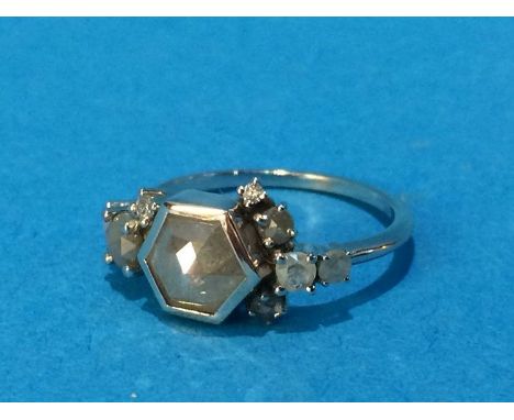 A white metal ring, stamped '585', mounted with a 'grey' diamond, size K