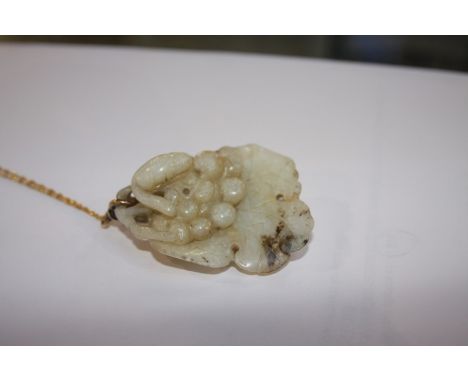 A Jade pendant, chain stamped '750' (chain 1.5gram)
