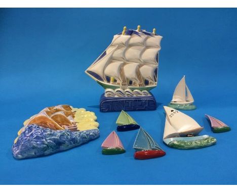 A Beswick Galleon wall plaque, number 7714, a Poole pottery galleon, four Wade yachts, Beswick yacht and a Poole yacht (8)