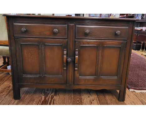 A dark oak sideboard, possibly Ercol 84cm x 125cm x 48cm