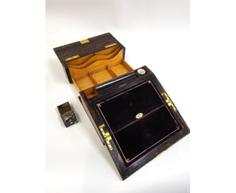 A coromandal wood writing slope with purple velvet insert for writing, a push-button/ spring mechanism for compartment reveal