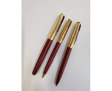 Three Vintage Parker writing implements including a fountain pen, push button ballpoint, and a propelling pencil. (3)