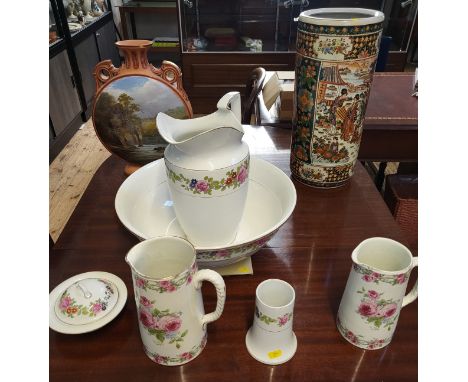 A Burslem jug, basin, lidded soap dish and brush holder, two other jugs with roses pattern, a terracotta moon flask and a Jap
