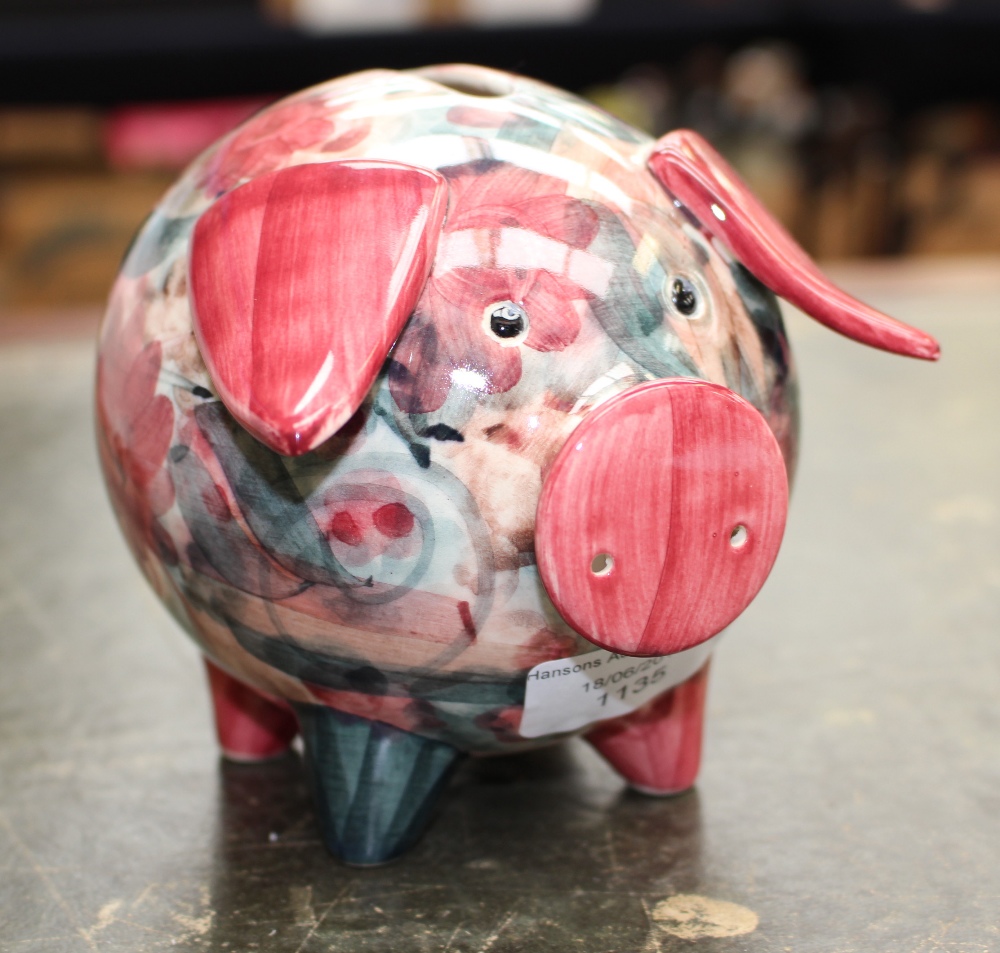 A Jersey Pottery pig money box, painted with absract floral decoration