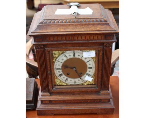 A Victorian oak bracket clock, with brass face and silvered chapter ring, Corinthian pilasters