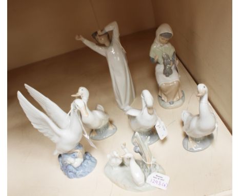 A Lladro figure of a yawning boy (af) a Lladro Nao figure of a seated girl petting a bunny rabbit and five Lladro Nao figures