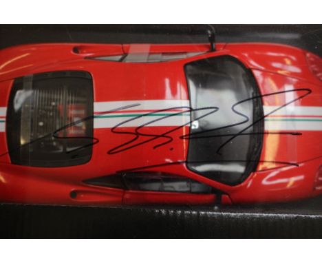 A Hotwheels Ferrari challenge large scale diecast car with box bearing the signature of Michael Schumacher and a boxed travel