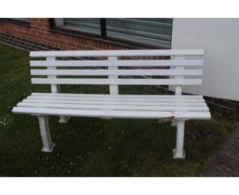 A modern white plastic slatted garden bench.