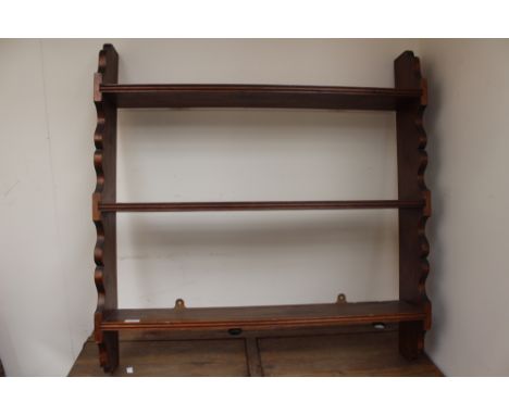 A pine three-tier wall shelf